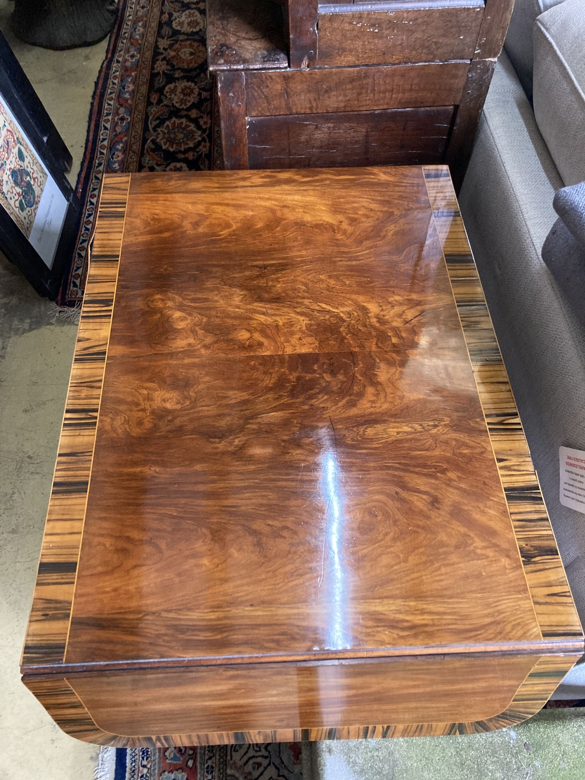 A Regency mahogany sofa table banded in coromandel, W. 3ft. D. 2ft. 2in. H. 2ft 4in.